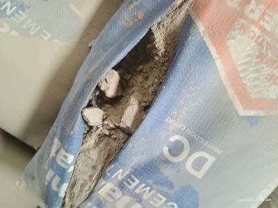 WET DAMAGED STOCK OF CEMENT BAGS OF APPROX. 6,243 BAGS